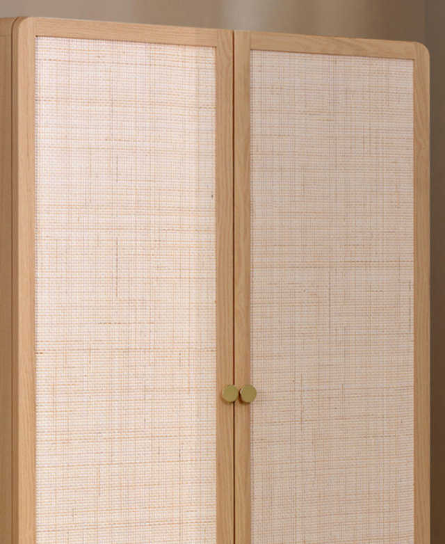 Large woven rattan panels are embedded into the front of the cupboard doors. Large woven rattan panels are embedded into the front of the cupboard doors.