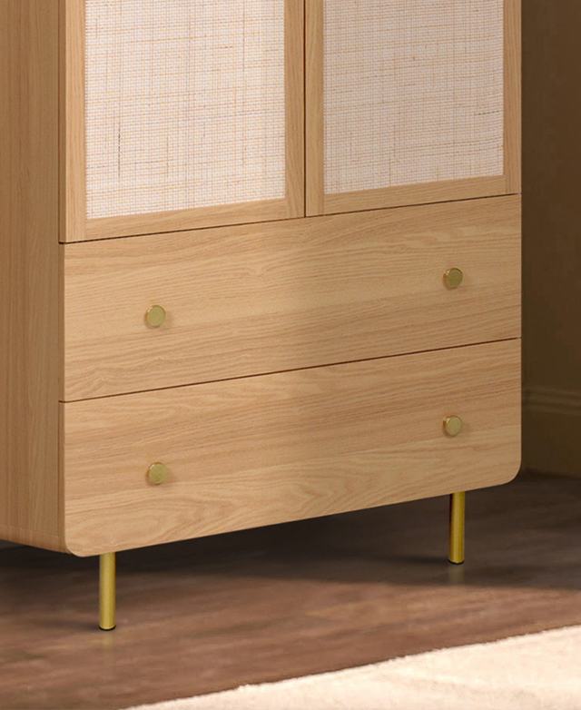 Rounded bottom corners, cylindrical metallic legs, and round metal knobs of the wardrobe are cropped into focus. Rounded bottom corners, cylindrical metallic legs, and round metal knobs of the wardrobe are cropped into focus.