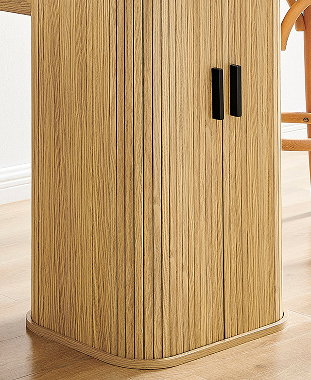 The pillar section of the bar table is in focus, highlighting the fluting and the bar-shaped black handles.
