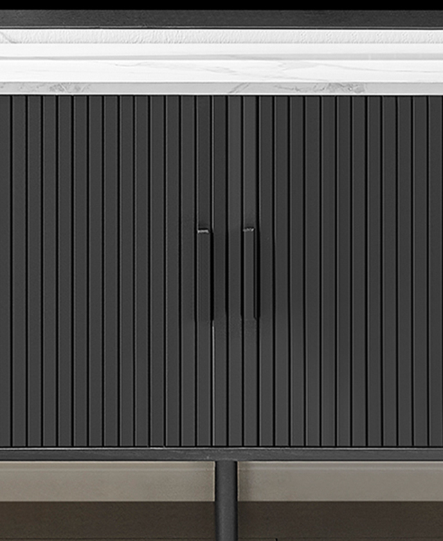 Front view of the charcoal cupboards with fluted fronts and subtle bar handles.