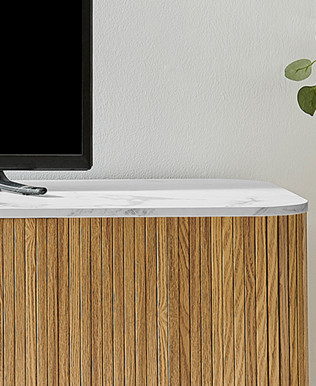 Cropped view of the oak TV unit's rounded ends and marble-effect top.