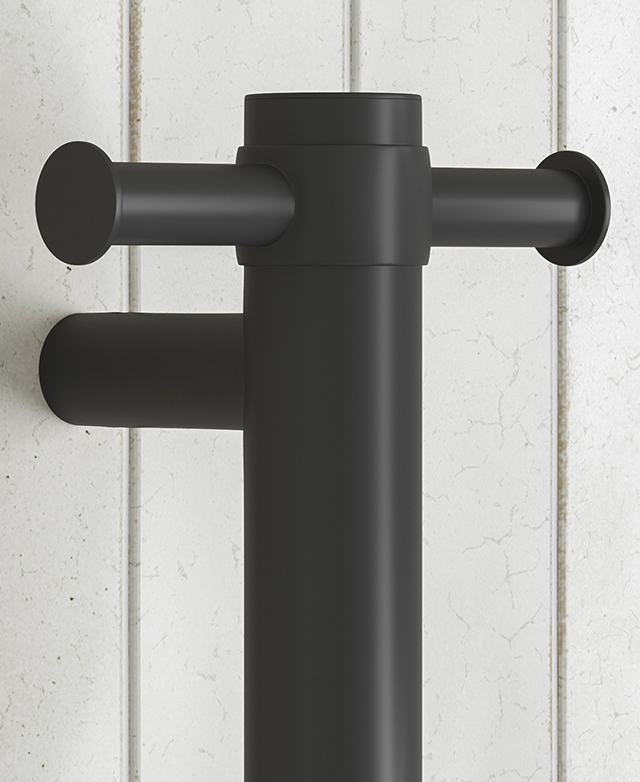 Matte black towel rail post with cylindrical rung junctions on white tiled wall.