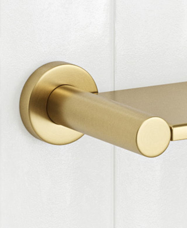 Brushed gold with shelf, round wall mount close-up on white tiles.