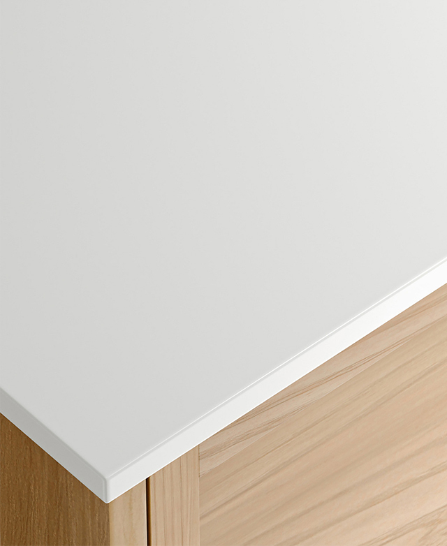 White top with rounded edge on light timber cabinet, showing clean, modern corner detail.
